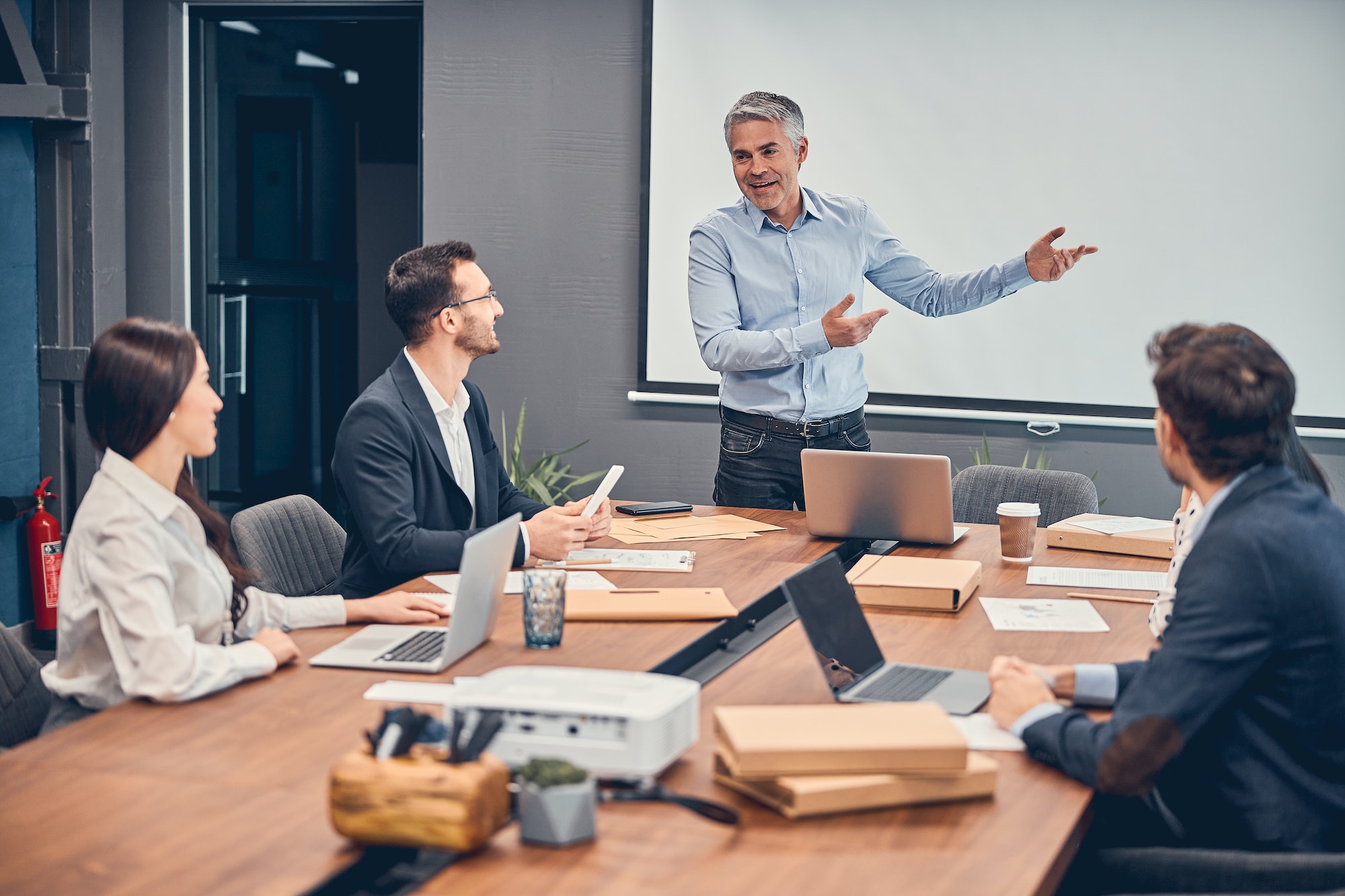 Stock photo of a manager speaking in a group meeting